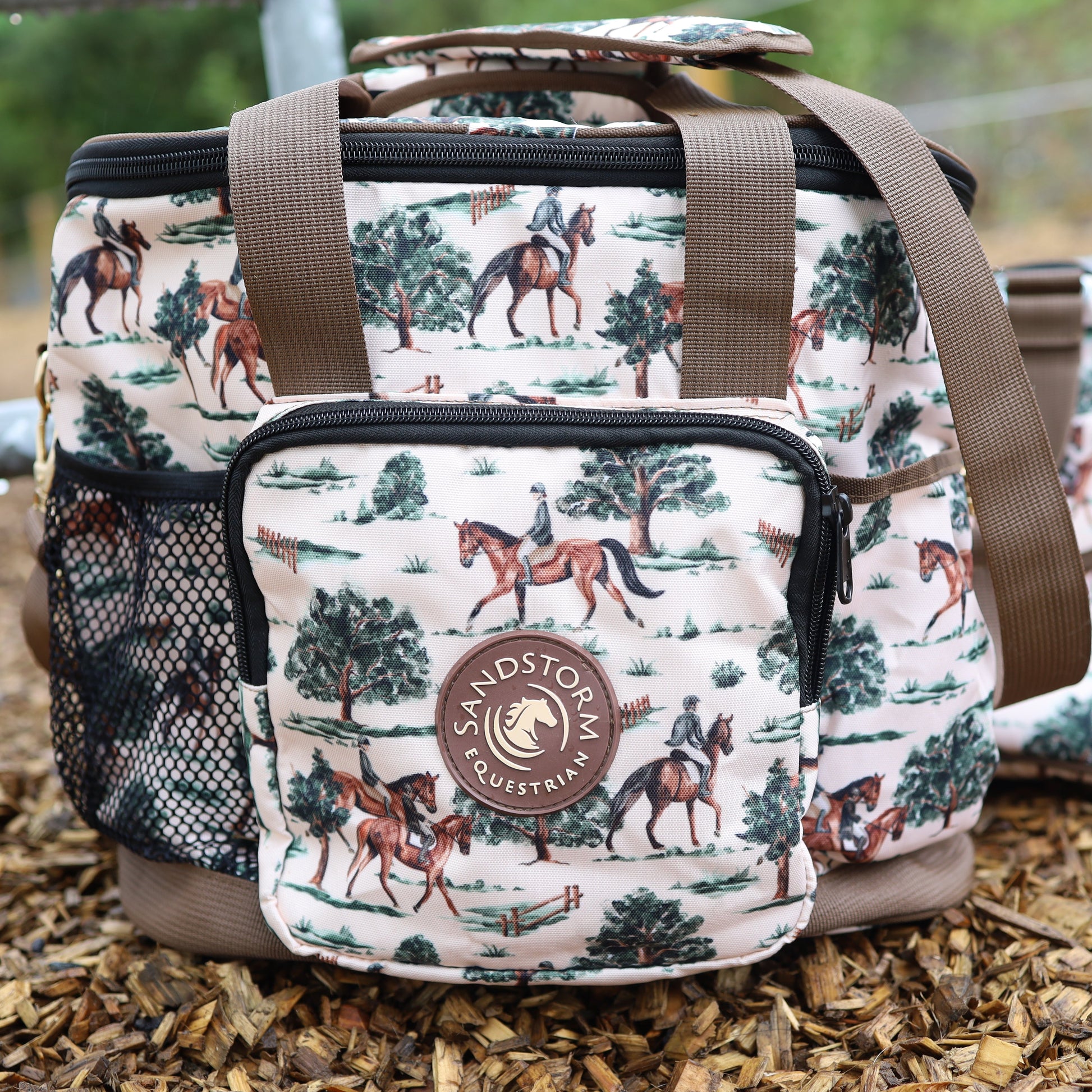 Patterned bag with horse and rider design on a wooden surface, featuring the brand 'Sandstorm'.