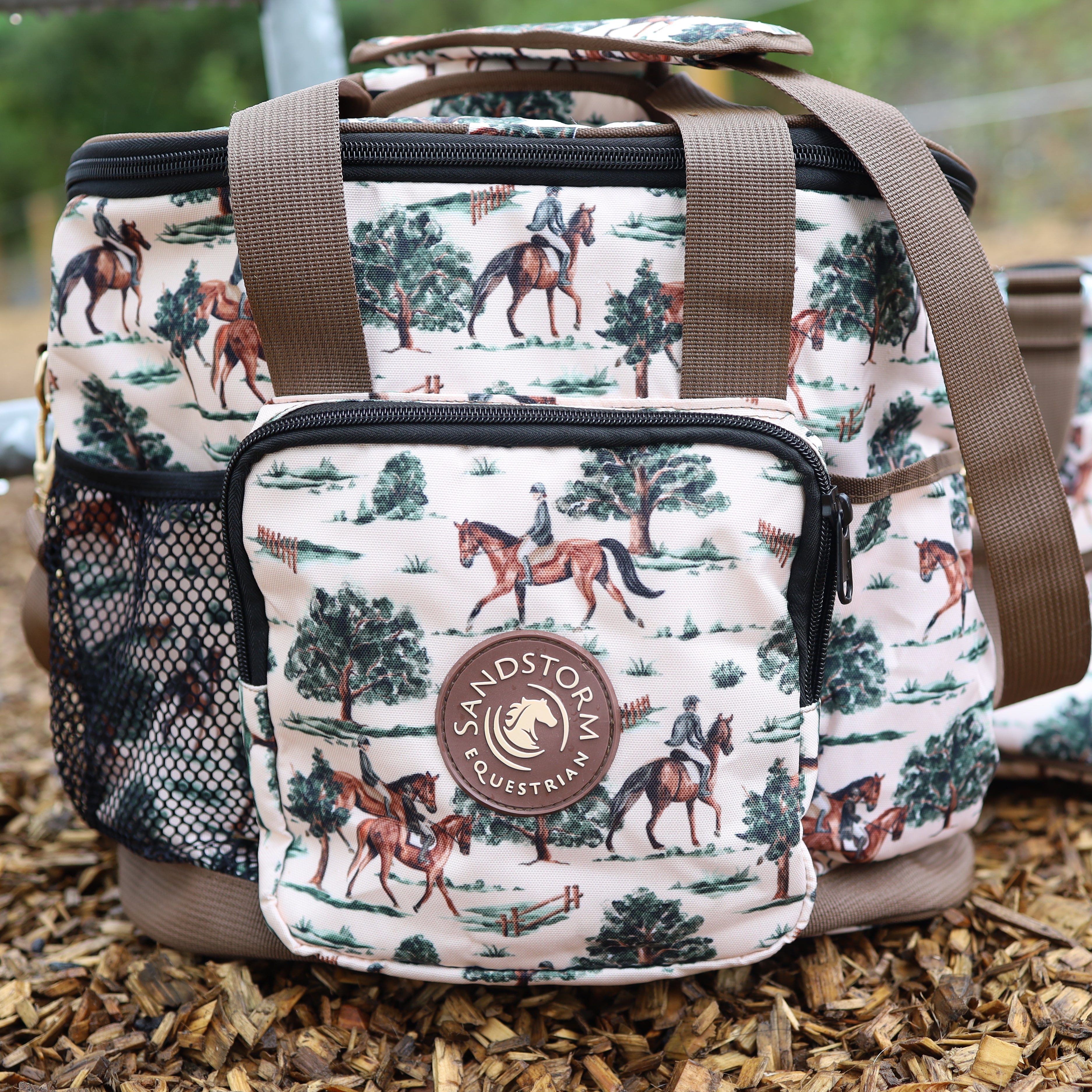 Patterned bag with horse and rider design on a wooden surface, featuring the brand 'Sandstorm'.